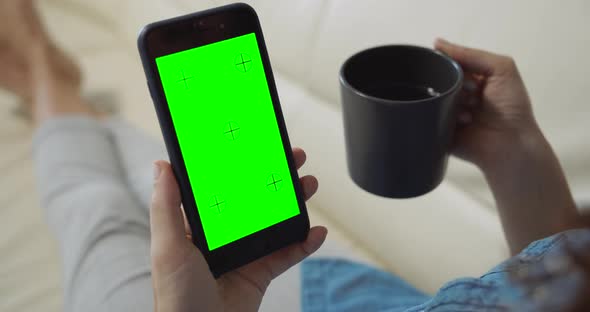 Woman Holding Greenscreen Smartphone