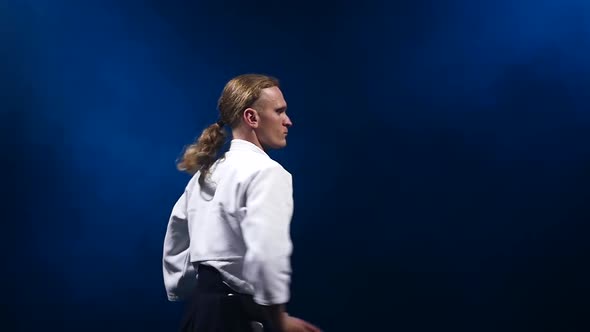 Master Participants of the Training in Special Clothes of Aikido Hakama Work Out the Methods of alt