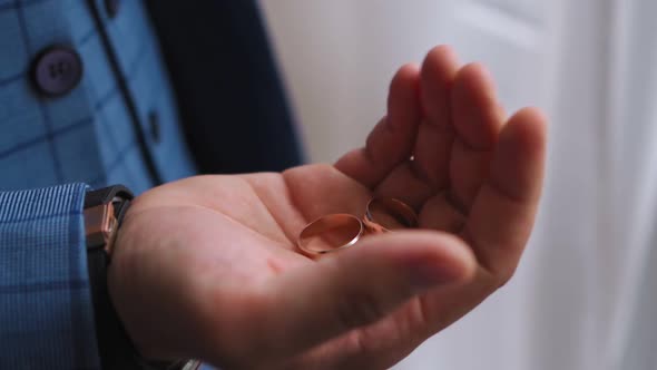 Groom Squeezes Wedding Ring in His Palm alt