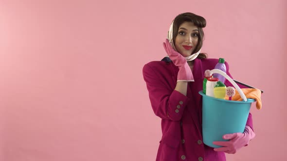 A Surprised Young Woman with a Bucket and Cleaning Tools