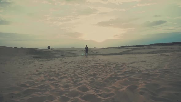 Man Is Walking in Desert