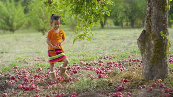 Young girl in Fall putting apple in pocket