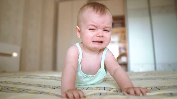 Baby Crying Lying on the Bed. Naughty Child