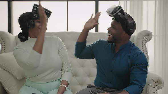Happy African American family couple Wear virtual reality glasses Play games