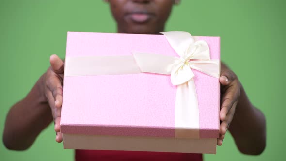 Young Happy African Woman Giving Gift Box
