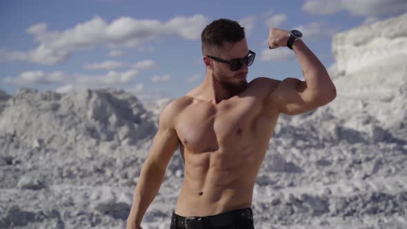 Muscular man posing outdoors. Handsome muscular shirtless hunk man outdoor alt