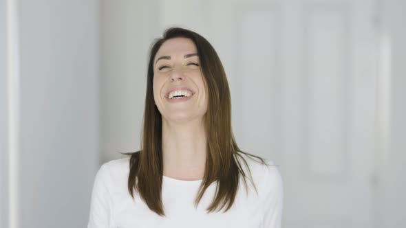 Happy woman laughing at camera alt