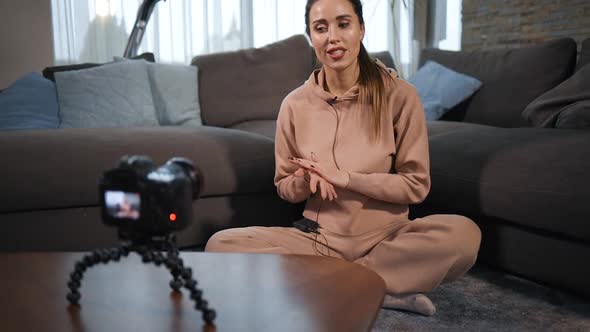 Young Female Yoga Blogger Records Tutorial Using Lav Microphone alt