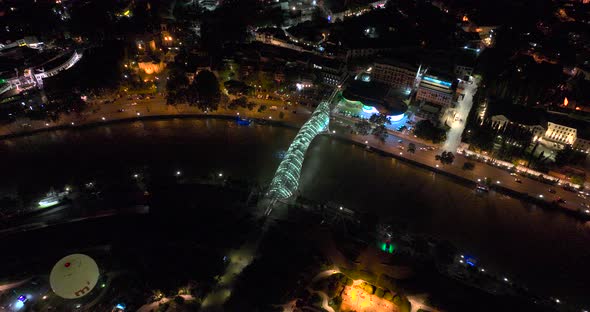 Night aerial view of Bridge of Peace and beautiful cityscape in the center of Tbilisi, Georgia 2022 alt