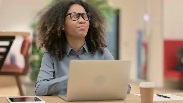 Young African Woman with Laptop Having Neck Pain alt