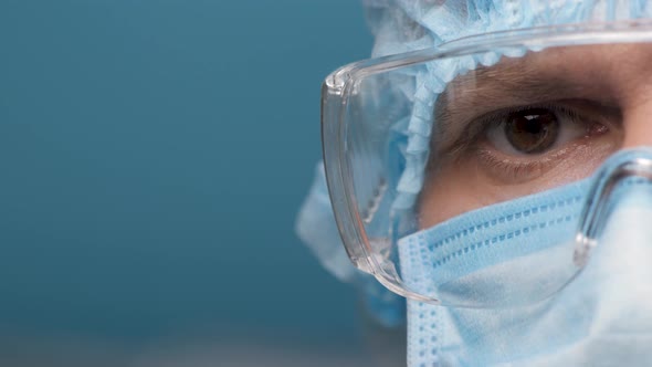 Portrait Employee Laboratory in Personal Protective Suit and Goggles. Focused Doctor's Eyes Looking