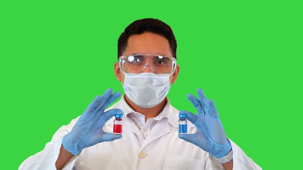 Doctor Showing in Hands Two Vial or Ampoules Concept of Choice Treatment on a Green Screen Chroma alt