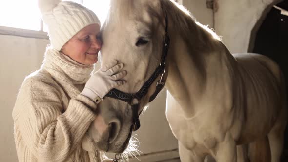 An Elderly Woman Loves Her Horse Kisses Hugs Strokes and Talks to Her