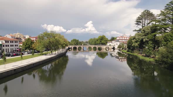 Aerial forward view on ground level over river Tamega. Chaves, Portugal. Real time alt