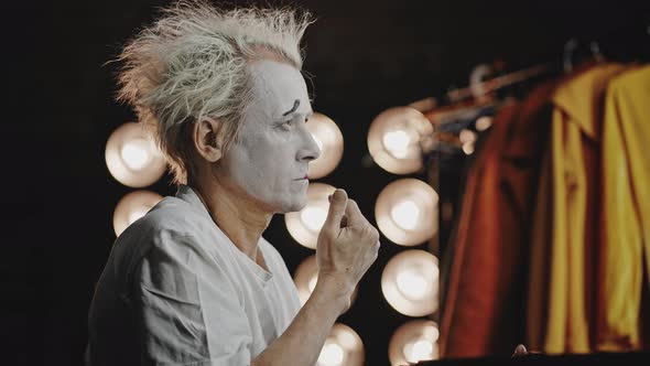 Mime Paints Lips Red Doing Theatrical Makeup in Dressing Room alt