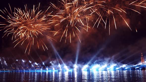 Festive Colorful Fireworks and Illumination in Dark Sky with Beautiful Reflection in Water