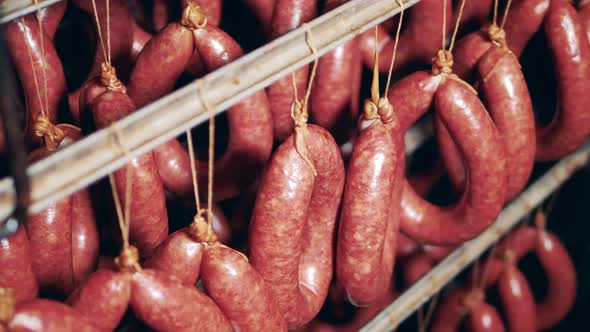 Smoked Tied-up Sausages Storaged in the Factory Fridge alt