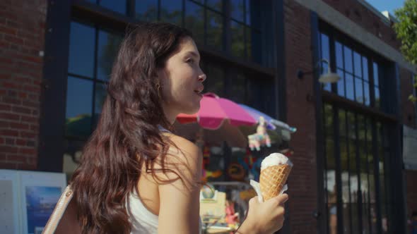 Brunette Enjoy Cold Dessert on City Stroll alt