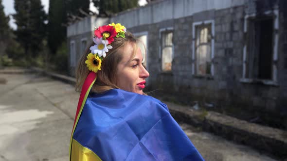 Ukrainian Girl Cries Near the Destroyed House Flag of Ukraine alt