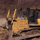 Bulldozer at Construction Site Shovels Soil Into a Heap - VideoHive Item for Sale