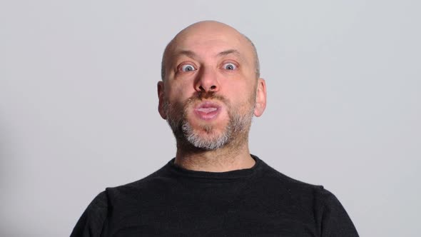 comic and funny man makes funny faces at the camera alt