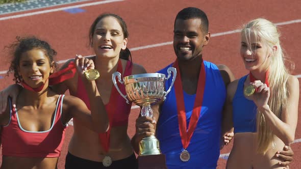 Happy Athletes Proudly Demonstrating Their Cups and Medals, Honored Awards alt