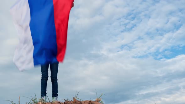 Blonde Girl Waving National Russia Flag Outdoors Over Blue Sky at Summer Russian Flag Country alt