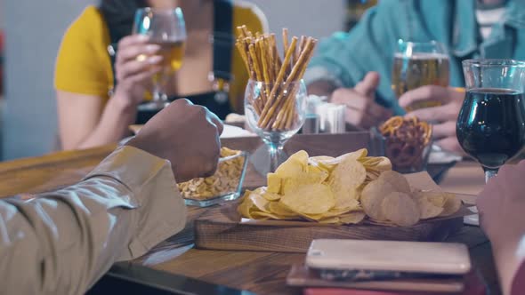 Wood table with beer and snacks inside bar