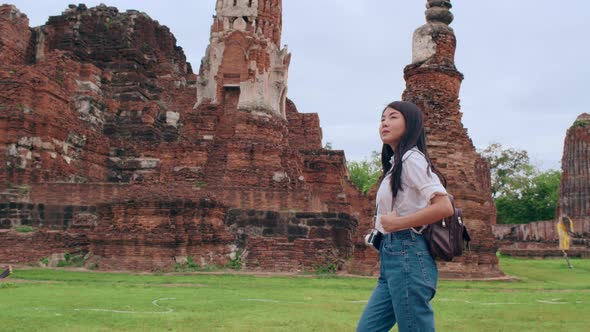 Japanese backpacker female enjoy her journey at amazing landmark in traditional city.