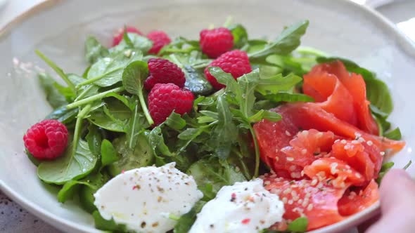 Summer salad with salted salmon, ricotta and raspberries. alt