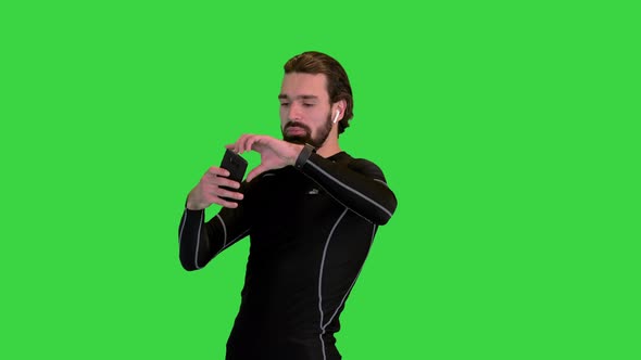 Running Fitness Man Using Phone to Take a Photo on a Green Screen Chroma Key alt