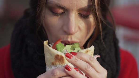 Young Girl Eats Shaurma Gyros Closeup alt