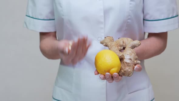 Nutritionist Doctor Healthy Lifestyle Concept - Holding Ginger Root, Lemon and Vitamin Pills alt