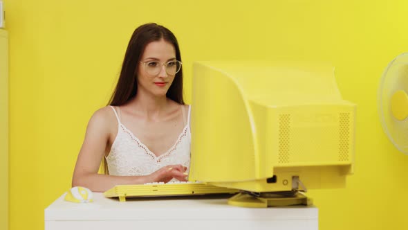 Woman Is Typing at Yellow Retro PC alt