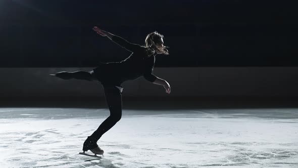 Slow Motion Cinematic Shot of Young Female Artistic Figure Skater is Performing a Woman's Single alt