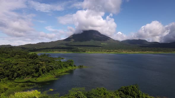 Long video of Arenal volcano behind Costa Rica's largest man made lake. Gigantic world famous landma alt