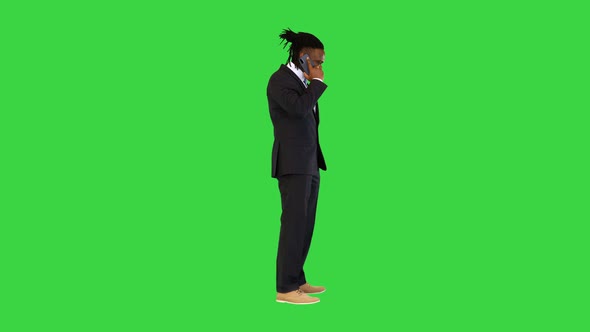 Black Man in Office Suit Talking on Mobile Phone on a Green Screen Chroma Key