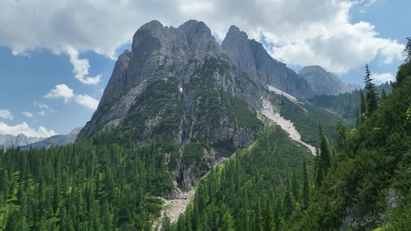 Hikers and travelers enjoy the beautiful mountain views as they have a walk in the Dolomites alt