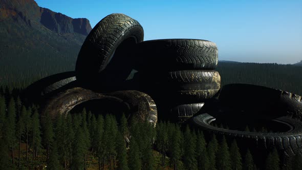 Concept of Environmental Pollution with Big Old Tires in Mountain Forest alt
