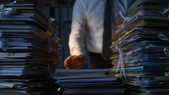 Office clerk stacking paperwork