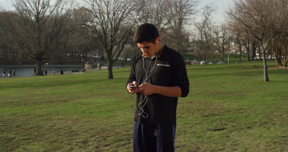 Young Man Choosing Music Before Starting His Run 05B