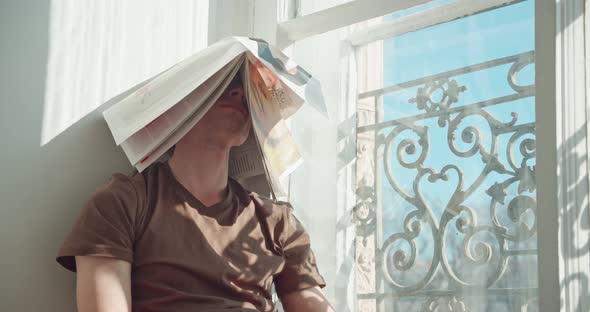 the Man Covered His Head with the Newspaper Tired of Fake News and the Endless Flow of Information alt