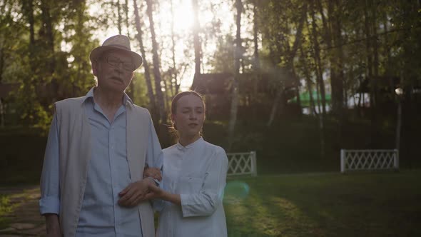 Nurse and Old Man Stand and Talk About Something alt