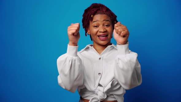 Cool Young Afro Woman Showing Thumbs Up Approves Something Blue Background