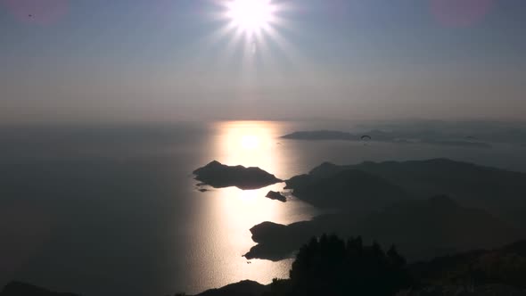 Paragliders Flying With Paragliding in Sky Over the Forest, Mountain Top and Sea alt