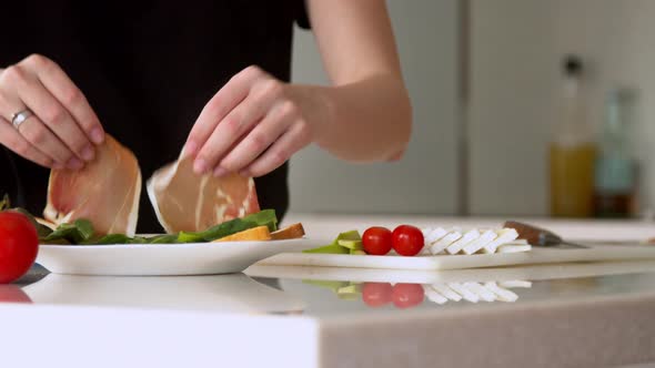 Woman Preparing Sandwich in Kitchen