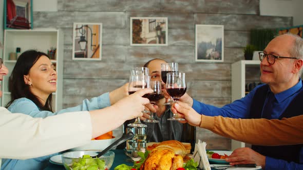 Happy Young Family Toasting with Wine Glasses alt