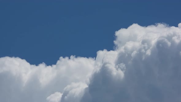 timelapse of white thick clouds filling in the blue sky frame alt