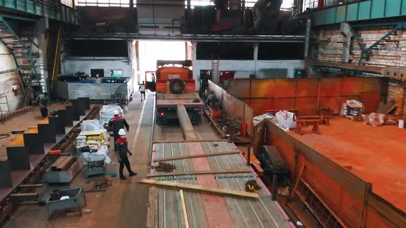 People at the Plant Prepare the Truck To Transport the Crane From the Plant alt