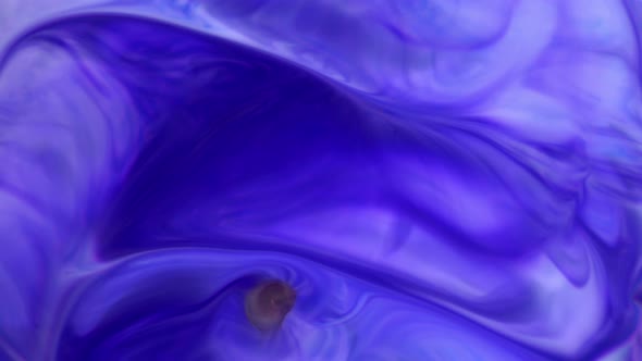 Ink in Water. Violet Ink Reacting in Water Creating Abstract Background